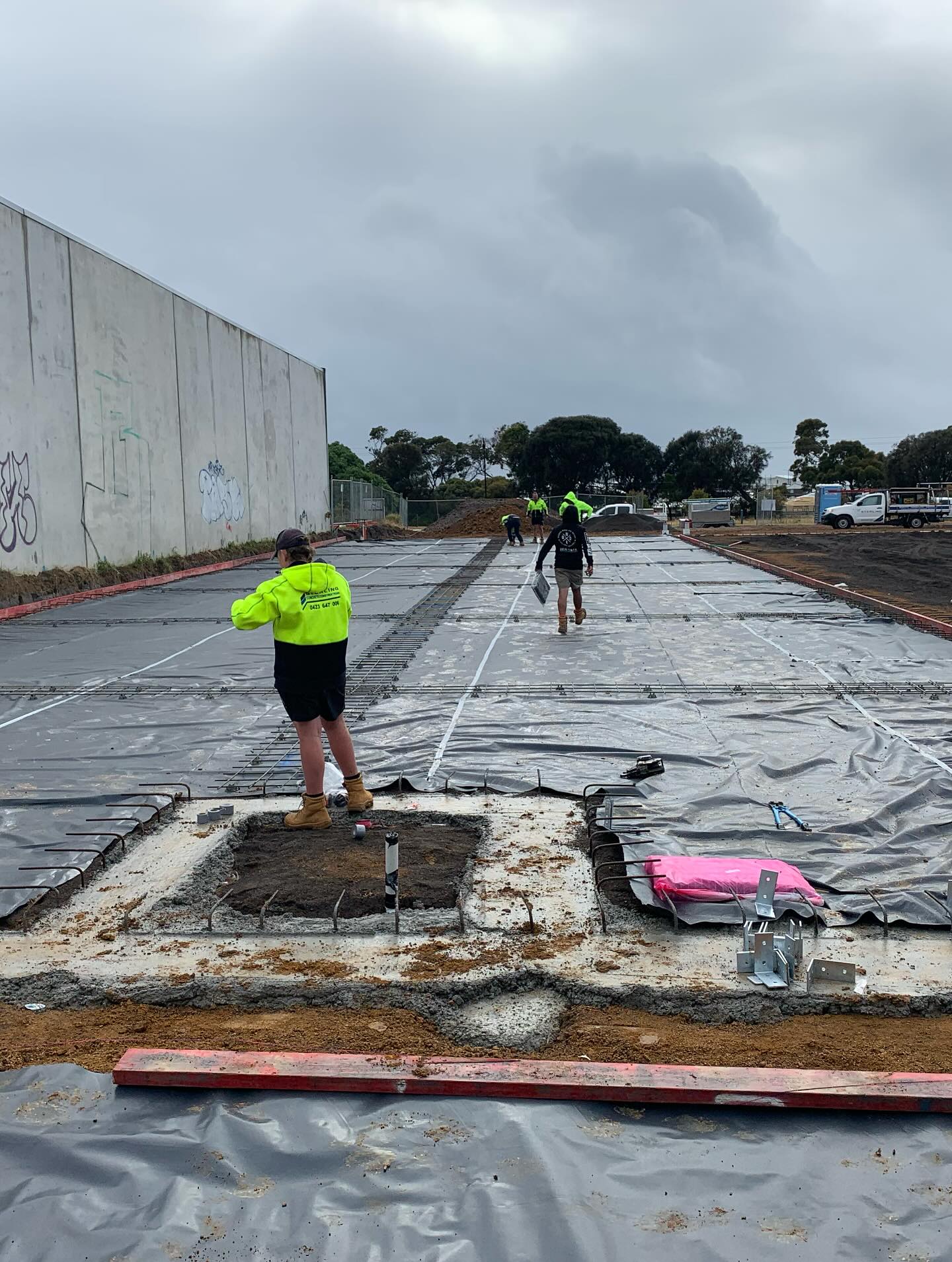 In-slab plumbing and electrical service coordination before a concrete pour