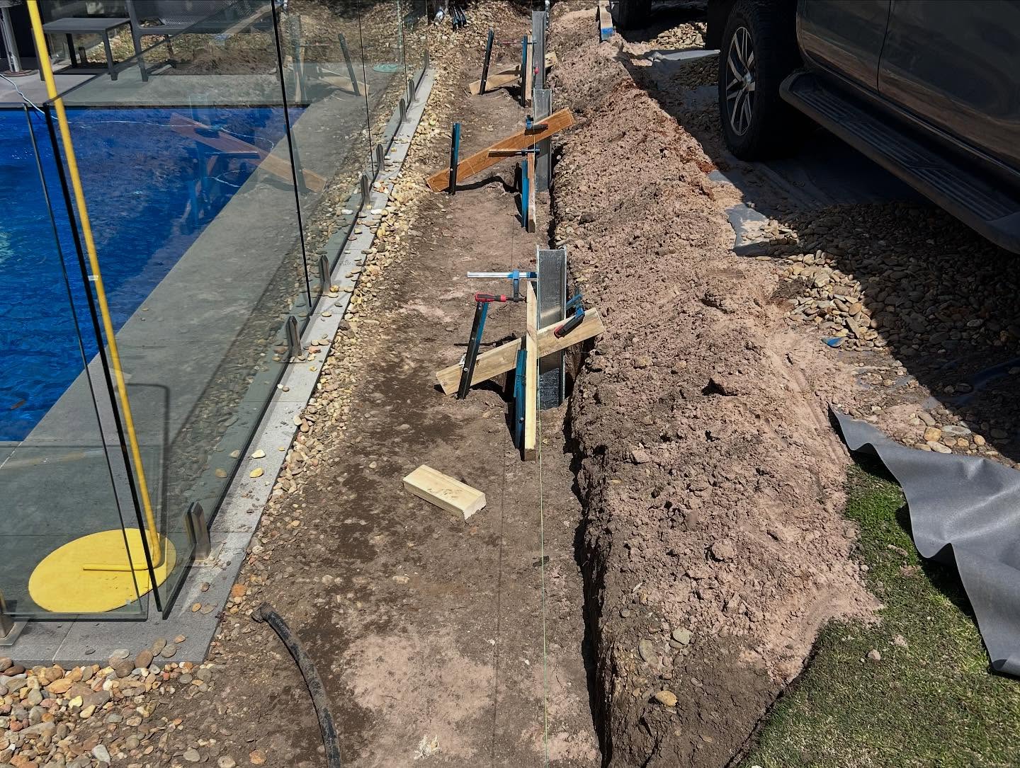 Structural concrete retaining wall holding a building platform